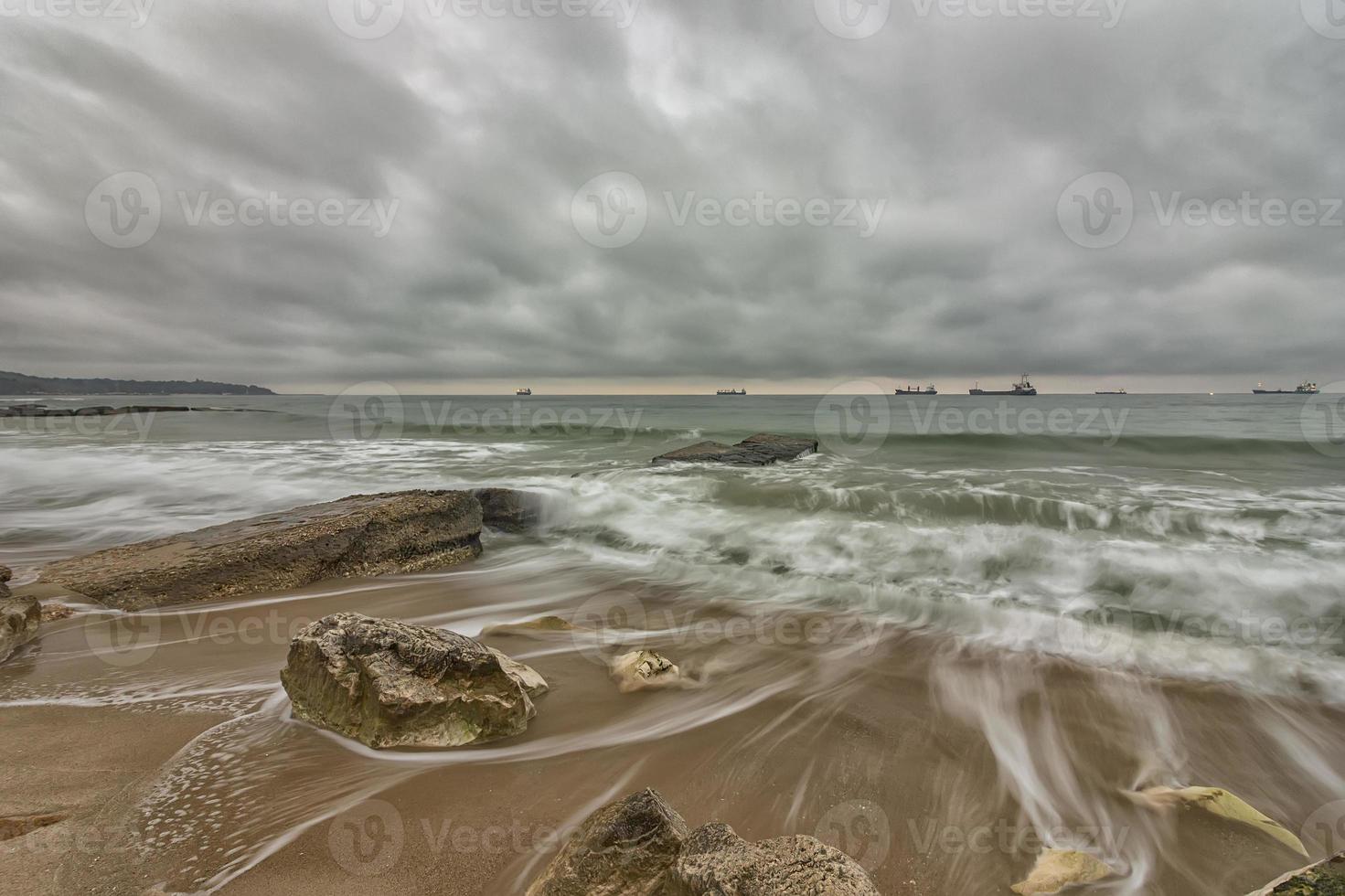 Beauty cloudy, long exposure seascape with slow shutter and waves flowing out. photo