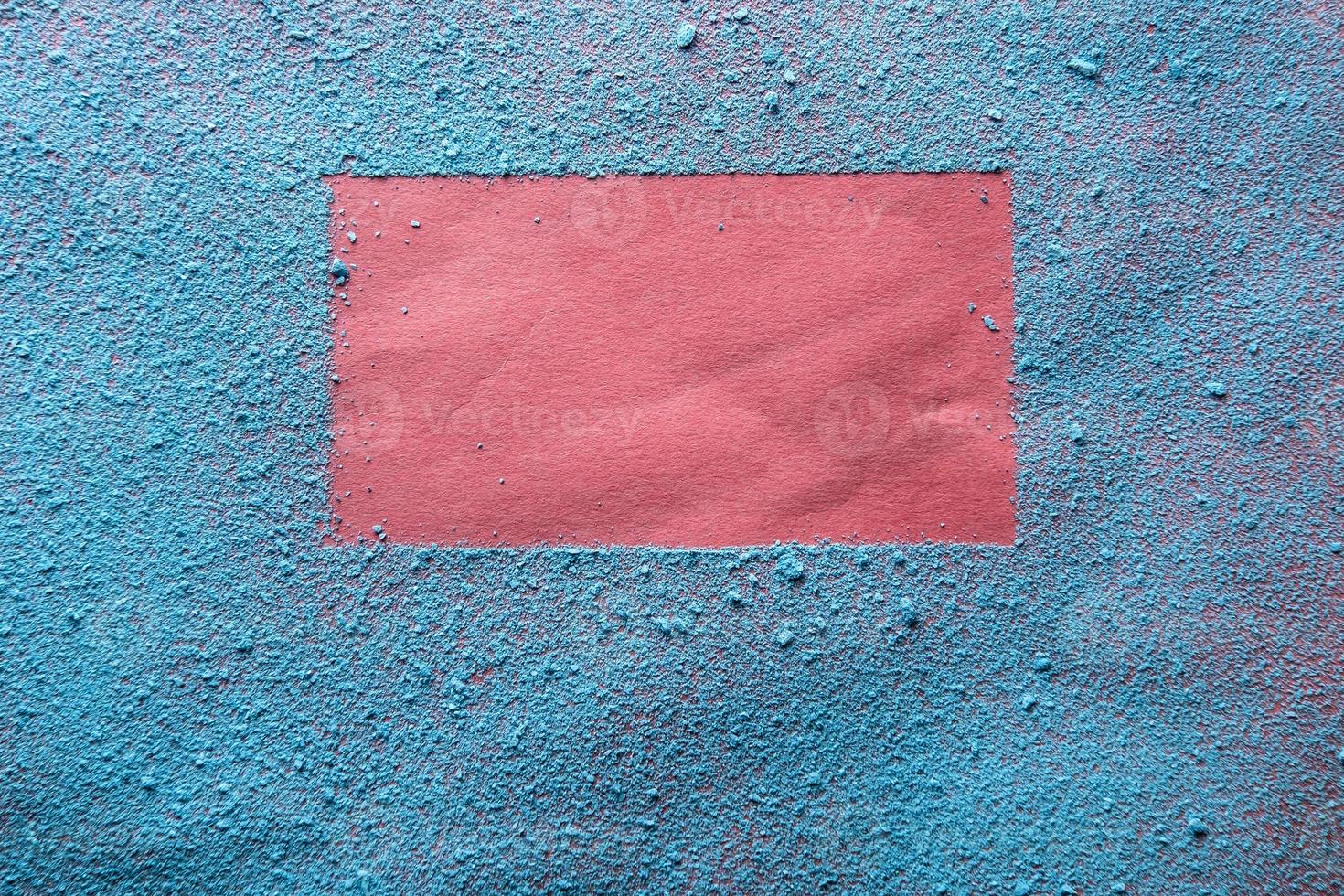 Imprint of a bright red frame on blue powder. Copy space. Abstract background. Top view. photo