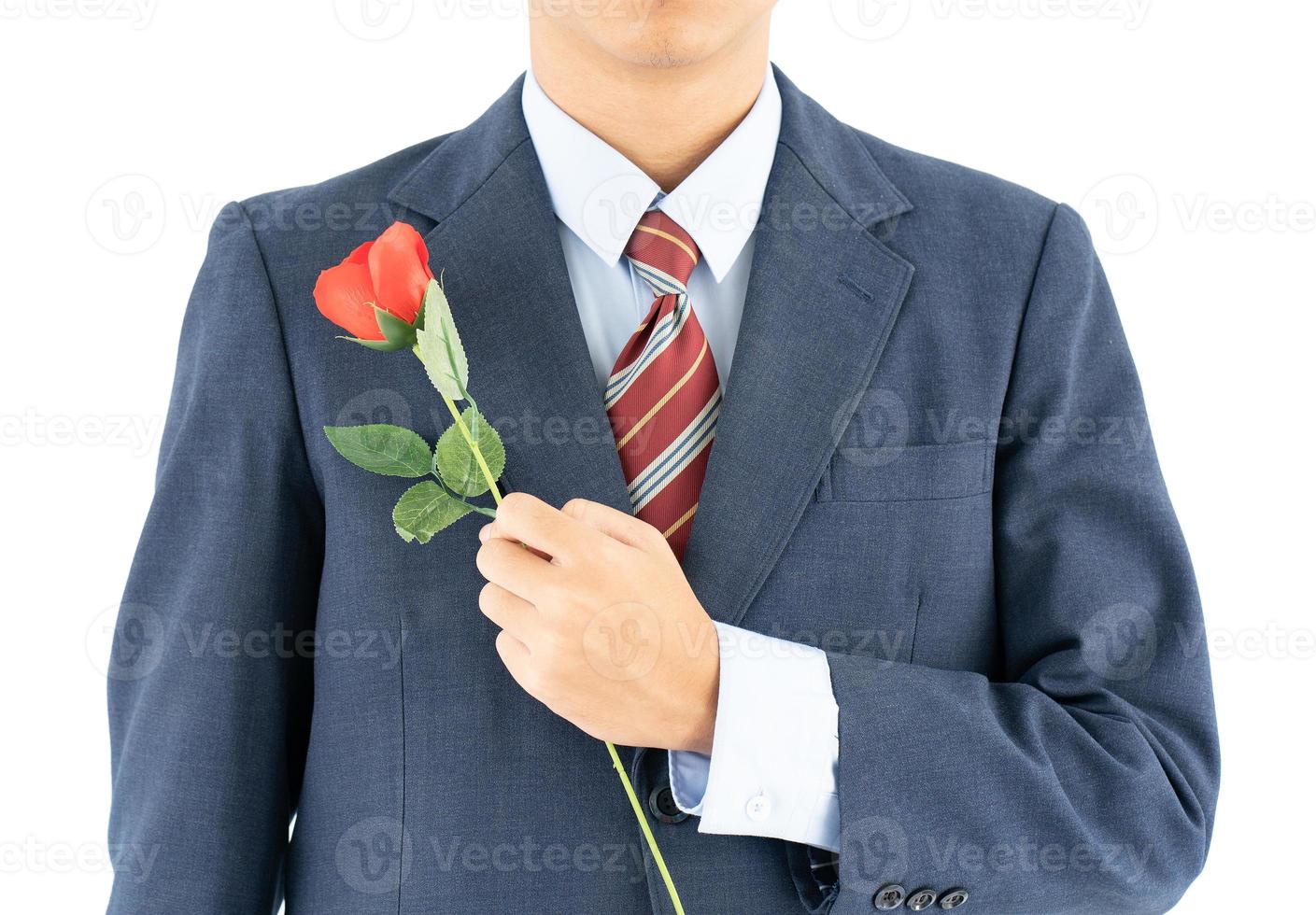 Businessman in suit with red rose on white photo