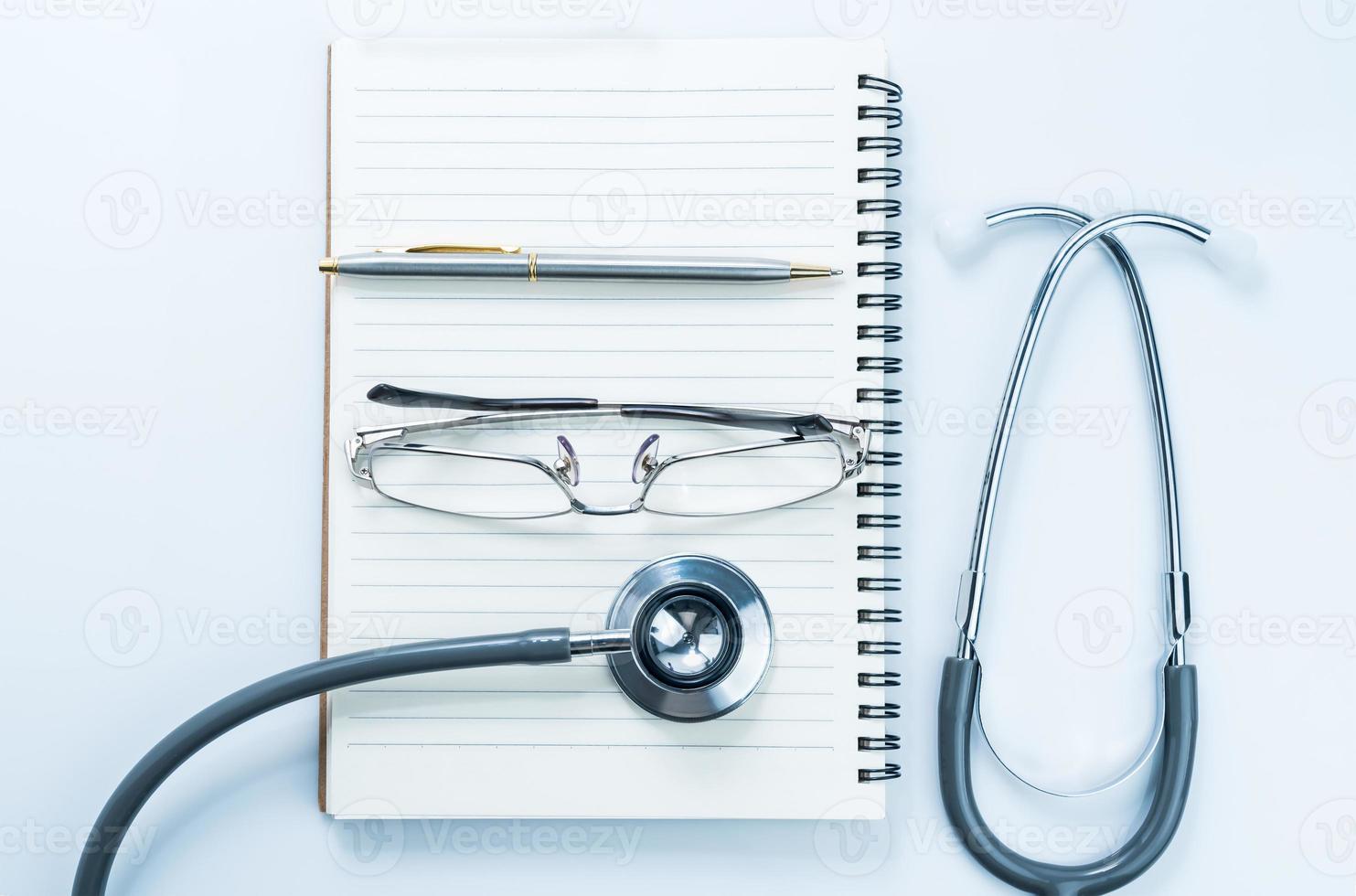 Medical stethoscope with blank notepad photo