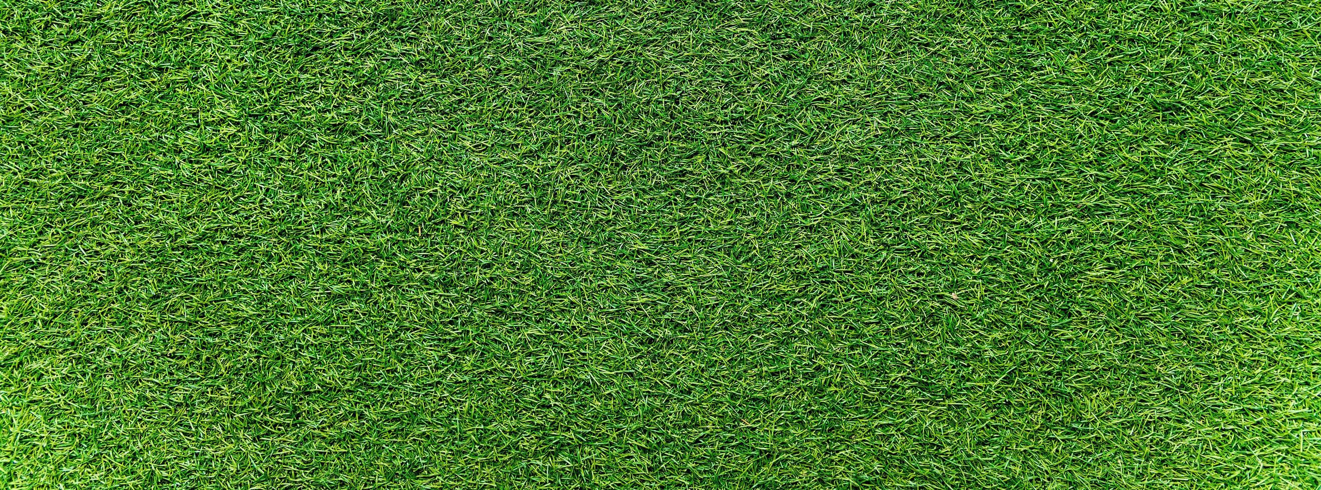 Panorama of green artificial turf flooring texture and background seamless photo