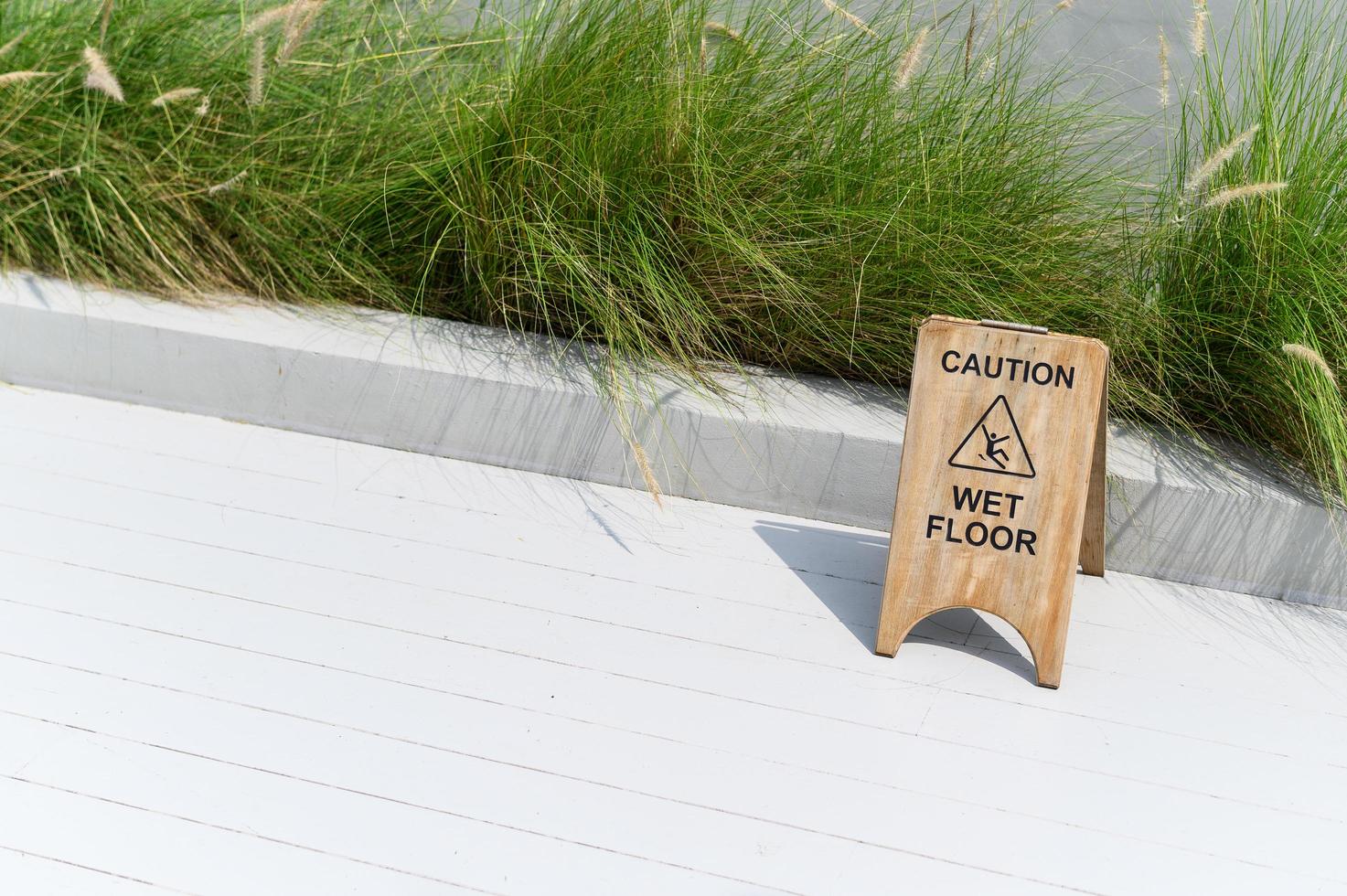 Wooden wet floor caution sign photo