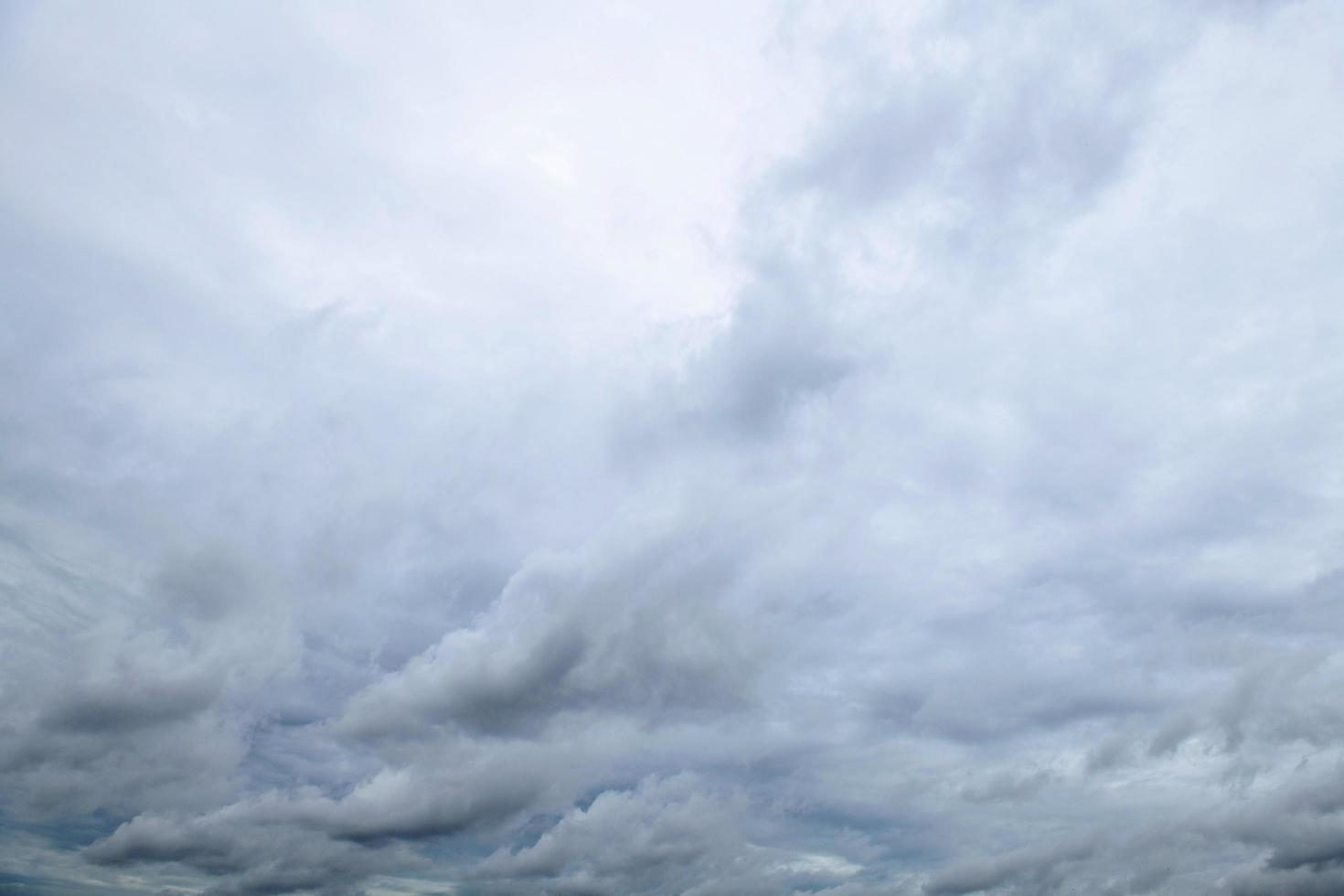 Storm clouds floating in a rainy day with natural light. Cloudscape scenery, overcast weather above blue sky. White and grey clouds scenic nature environment background photo