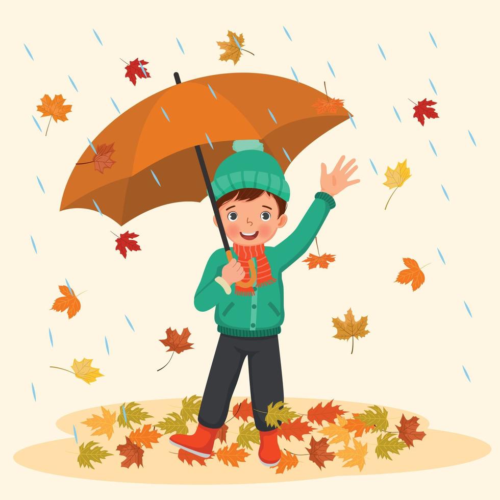 happy little boy holding umbrella under rain with fallen leaves in autumn vector