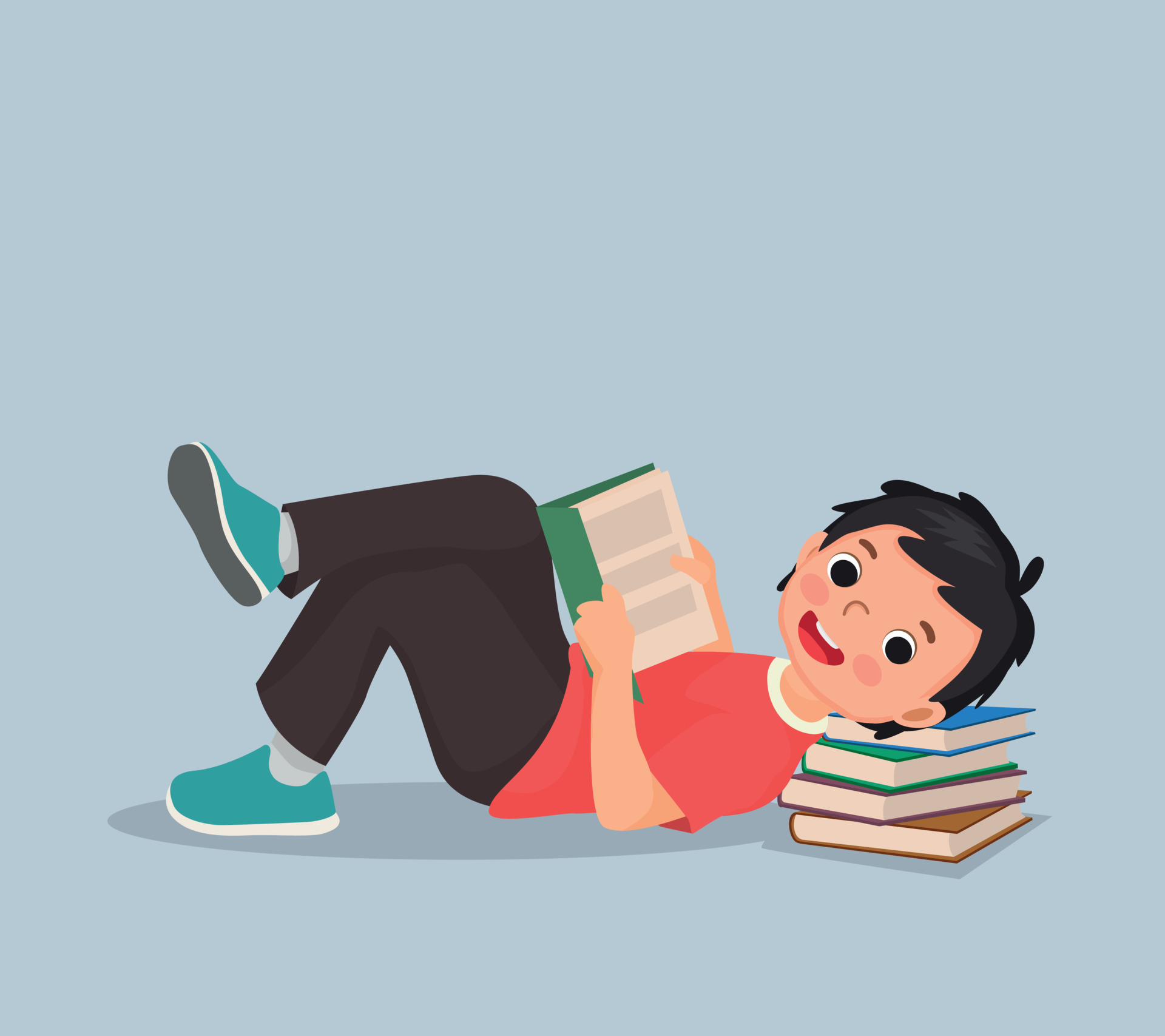 Cute little boy reading book lying on the floor with head on stack of