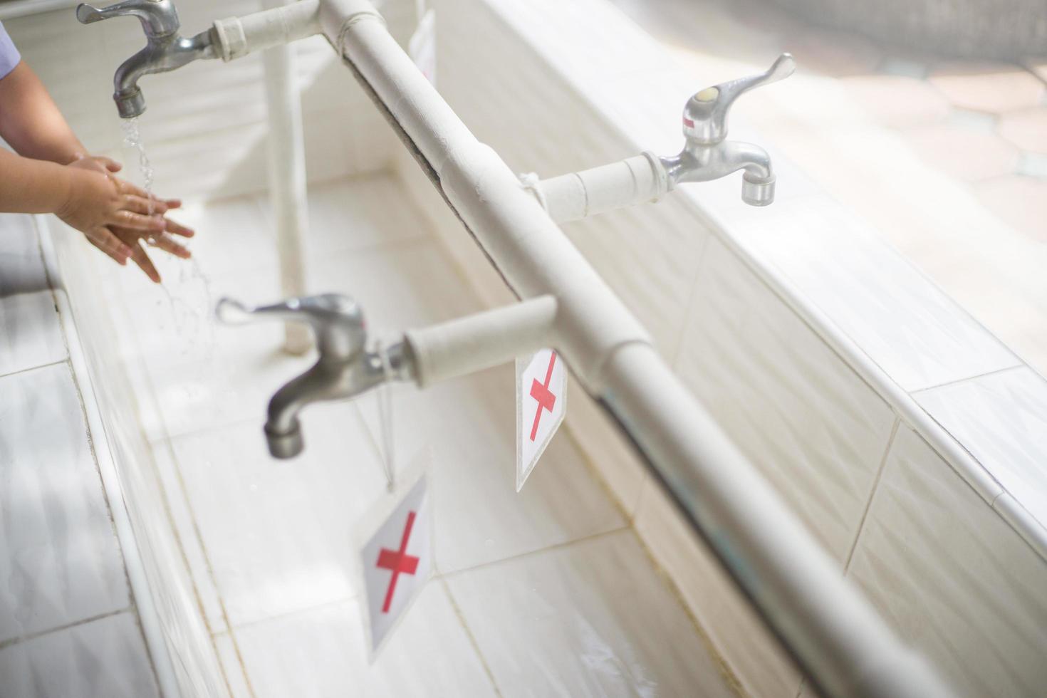 Child washing hand for virus protection photo