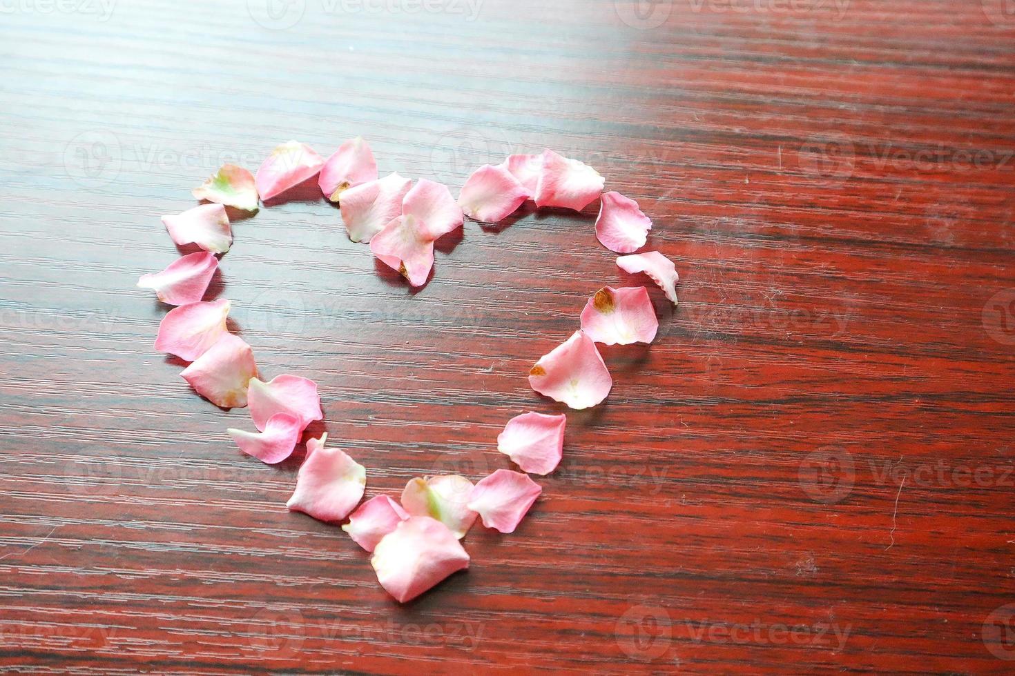 A heart shape made of pink petals photo