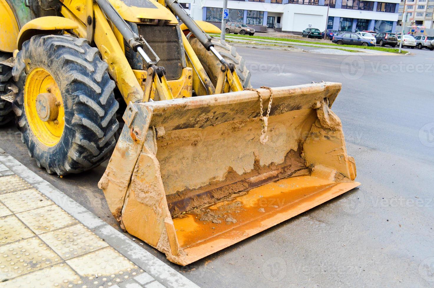 Large iron metal industrial heavy bucket of excavator, bulldozer, specialized construction equipment for road repair and excavation of the earth photo