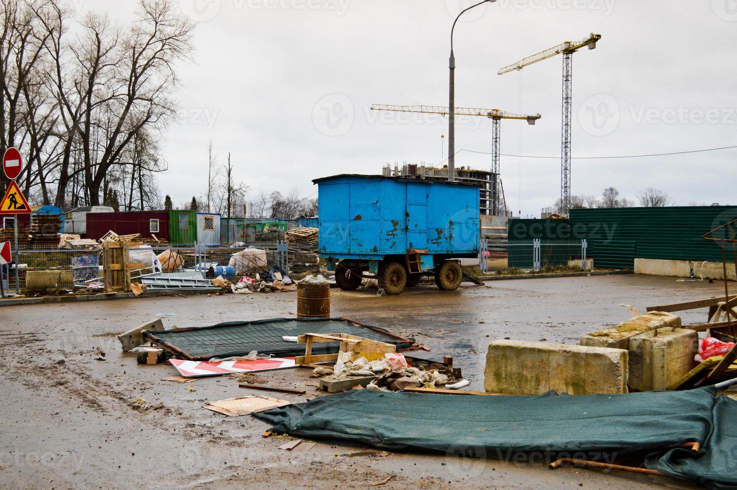 Small temporary houses of builders from containers at an industrial construction site. Block-modular construction city with change houses for workers photo