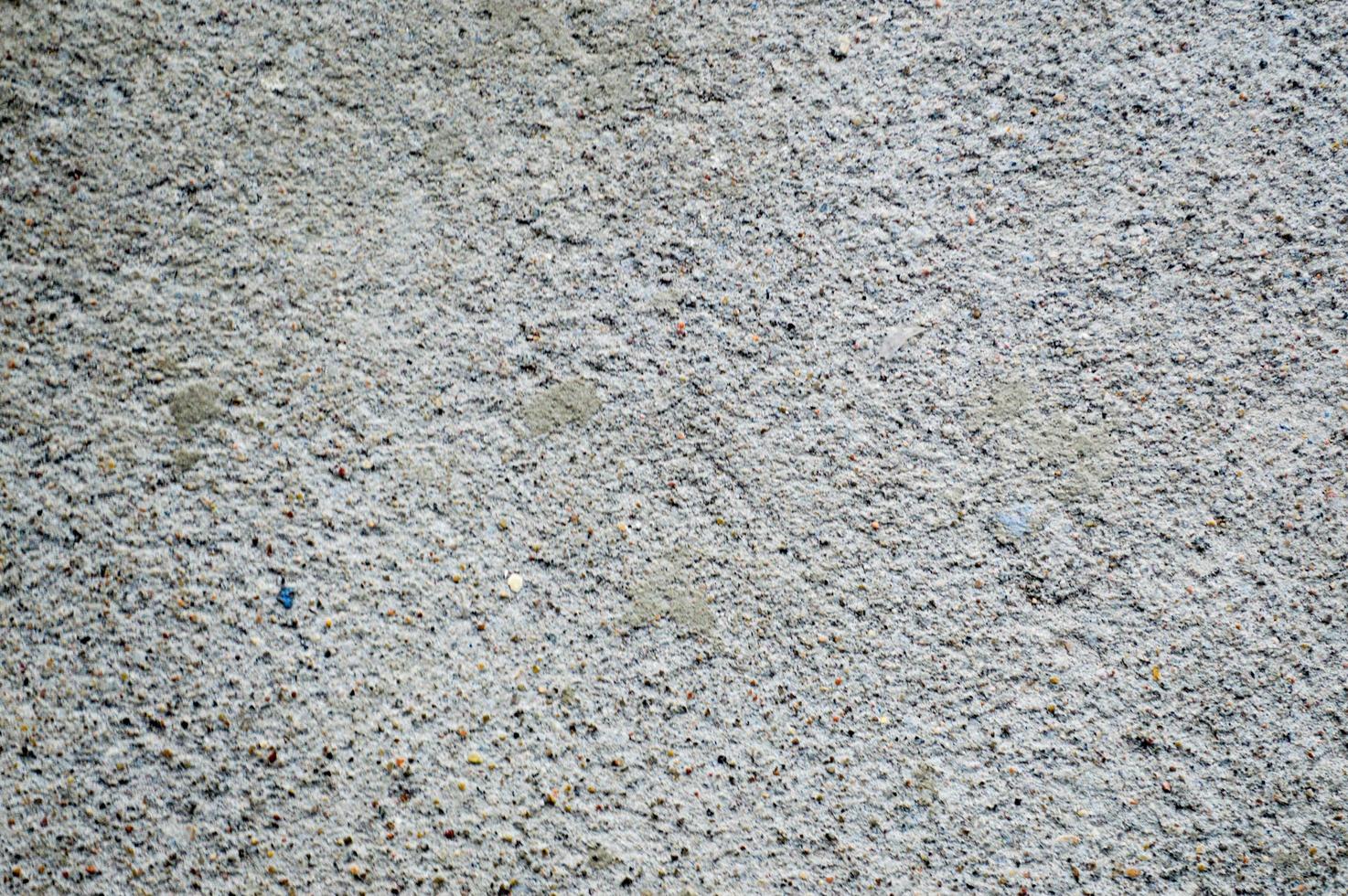 Wall made of gray solid, rusty, embossed building concrete. Texture, background photo