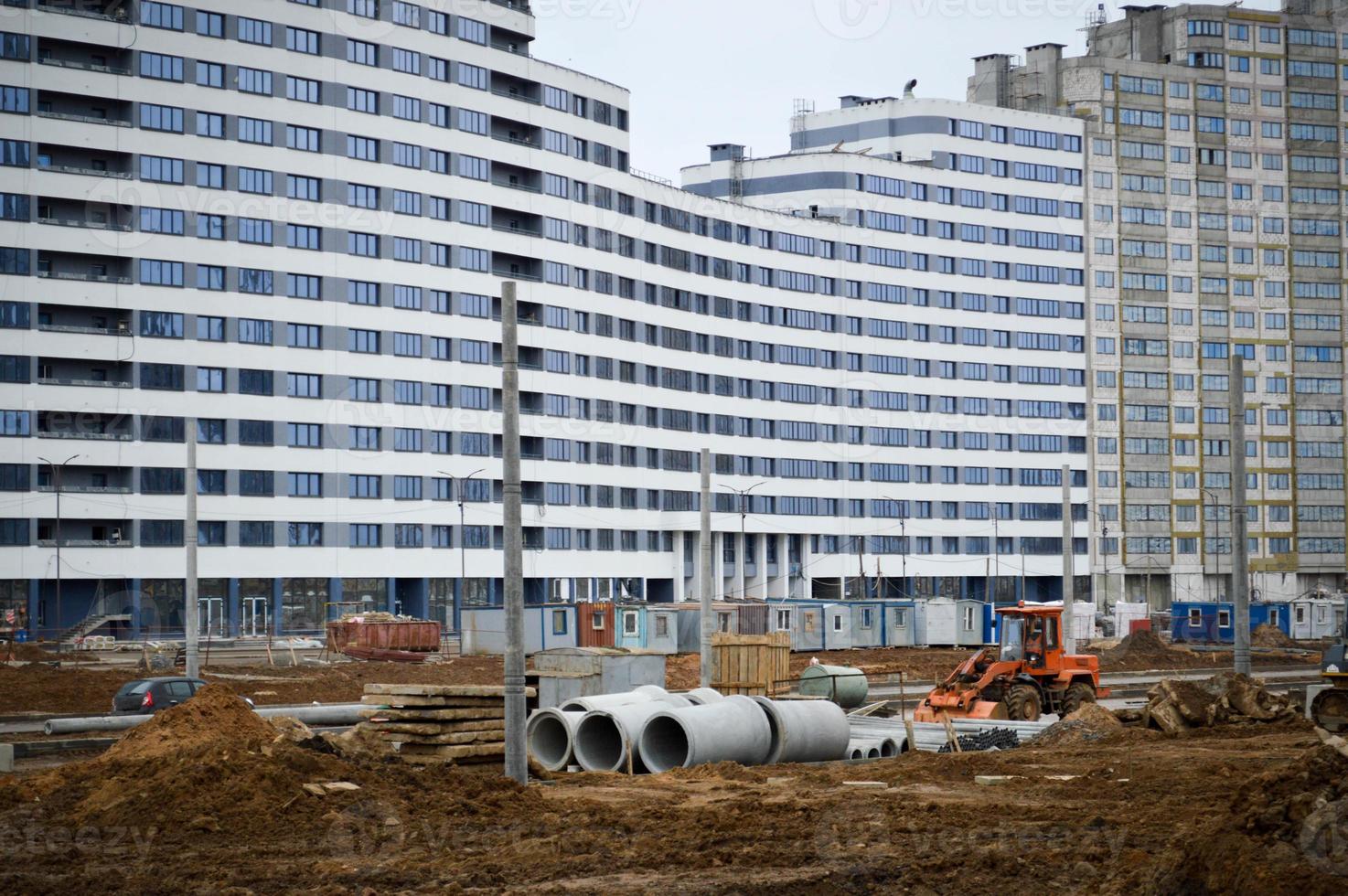 Construction of a large multi-storey comfortable concrete cement modern new monolithic-frame multi-storey building with windows, walls and balconies photo