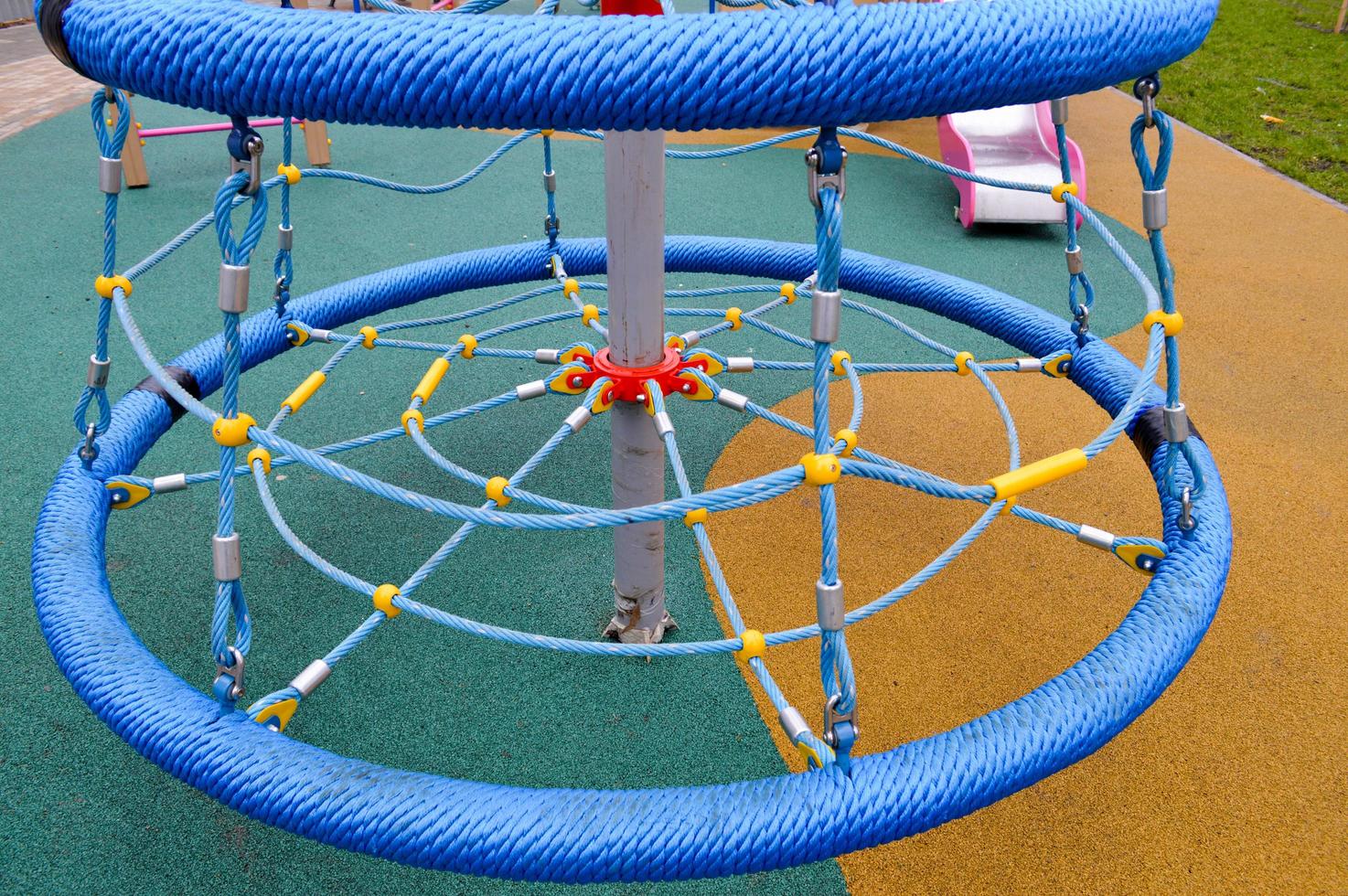 New modern safe outdoor playground in the open air with exercise equipment and toys in a new district of the city in the courtyard of a new building photo