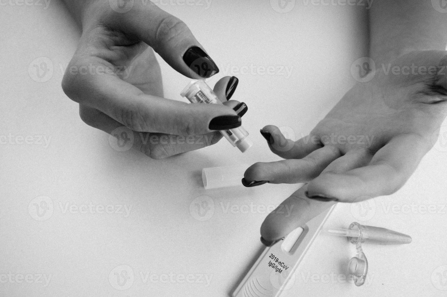 puncture of the finger with a lancet. quick blood test. express diagnostics. self-analysis, set for taking blood at home. fast finger puncture for blood sampling photo