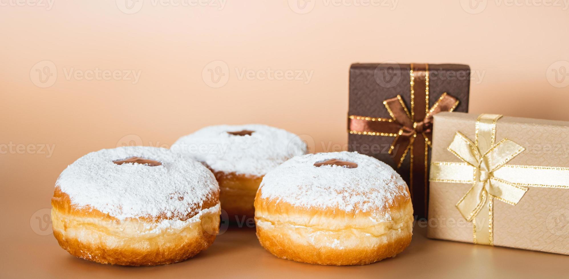 Happy Hanukkah. Traditional Jewish dessert Sufganiyot. Celebrating Judaism holiday. Donuts with jam and sugar powder. photo