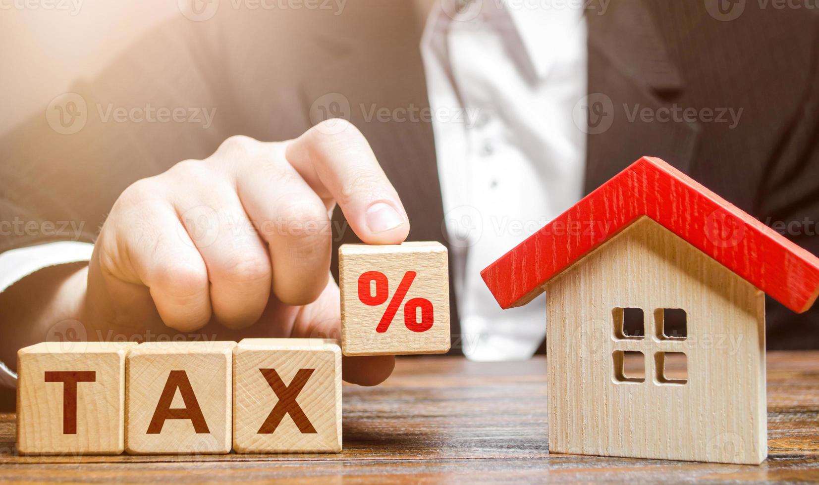 Man holds a percentage of real estate tax. Taxation on purchase or sale of a home. Maintenance of housing and land. Tax interest. Fees and duties. Rental business. Return on investment. Taxes relief photo