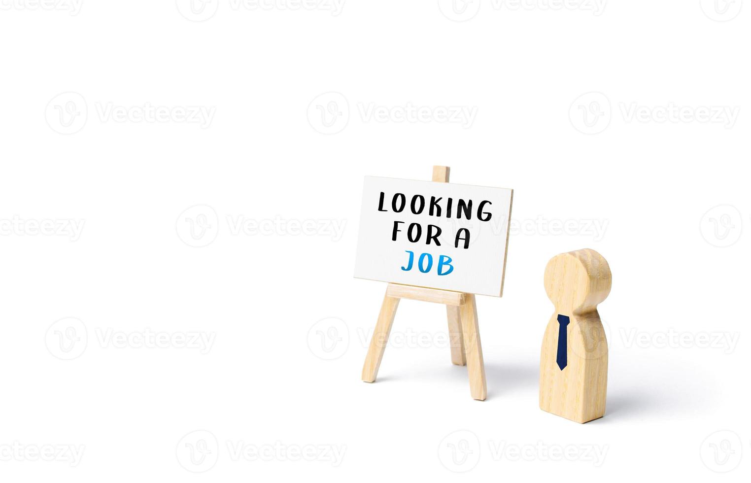 Unemployed employee figurine looking for a job. Finding a better job. Change of workplace. Search and recruitment of new employees for work. Hire staff. Employment Agency. Recruiting, staffing. photo