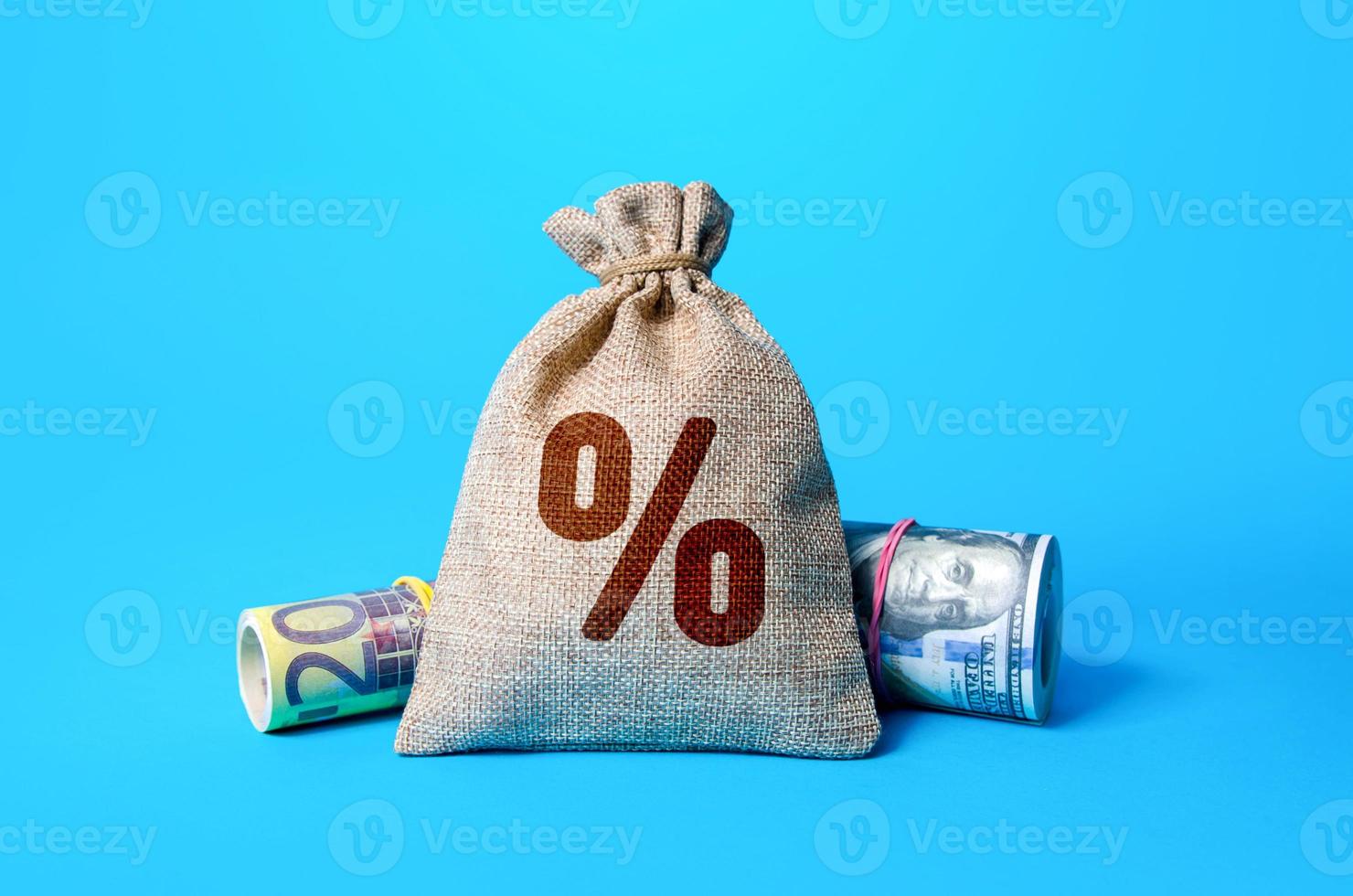 Money and a bag of interest. Official interest rates. Inflationary risks and regulation of the financial system. Deposit or loan. Key Policy Rate. Profitable investment of savings. Dividend photo