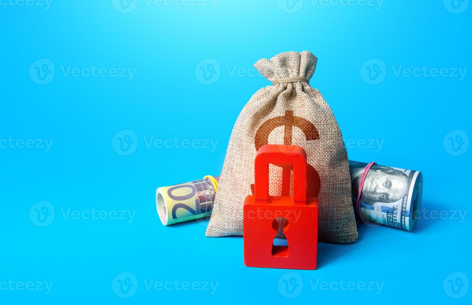 Dollar money bag and red padlock. Sanctions and Restrictions. Freezing of assets, seizure of savings and property. Unavailability of loans, low credit score. Fund reservation. Transaction restrictions photo