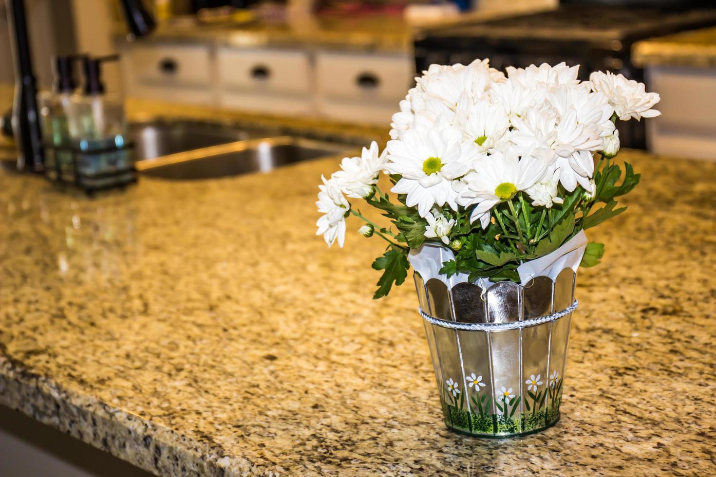 Arrangement Of White Pansies On Kitchen Granite Counter photo