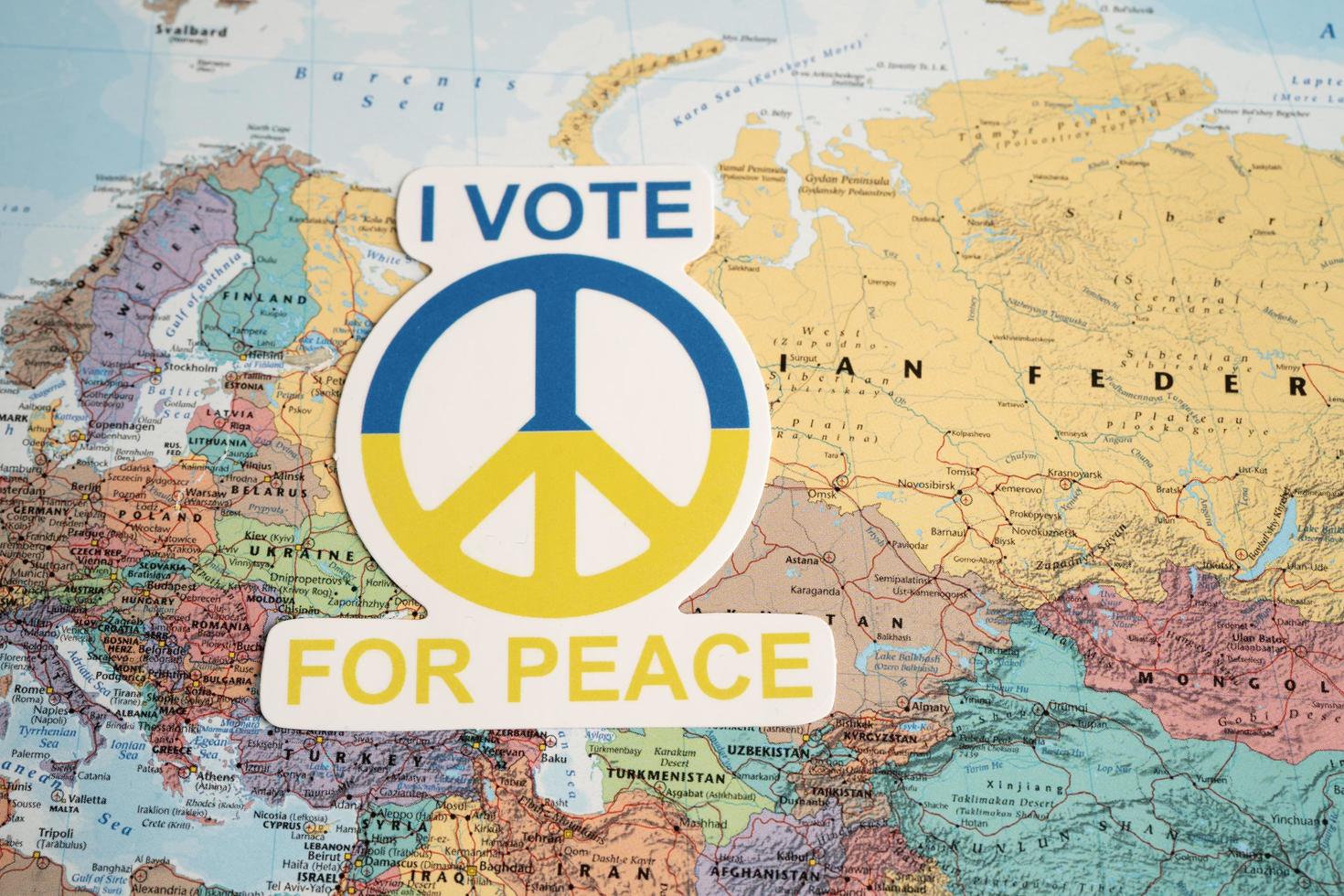 Bangkok, Thailand - September 1, 2022 I vote for peace text with heart flag on world map, stop war with Russia concept. photo