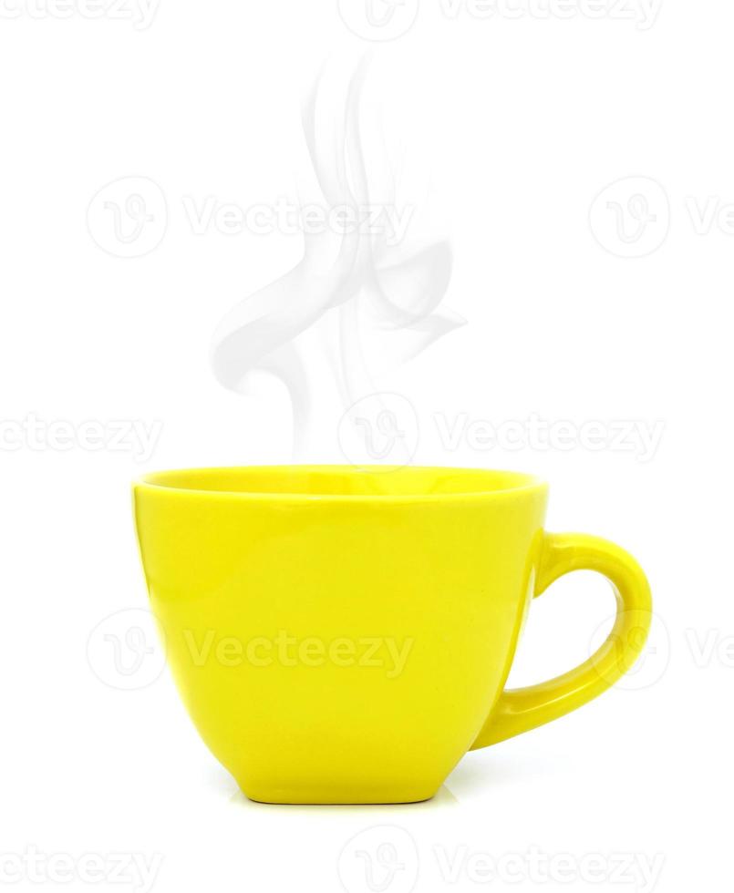 Yellow cup with hot drink on white background photo