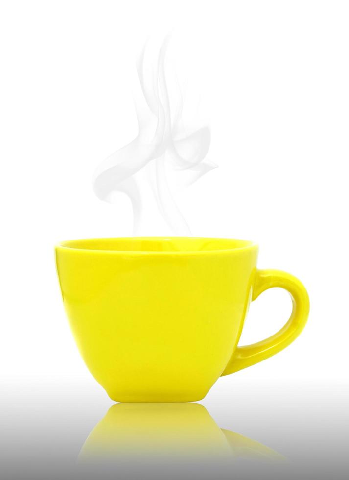 Yellow cup with hot drink  on reflect floor and white background photo
