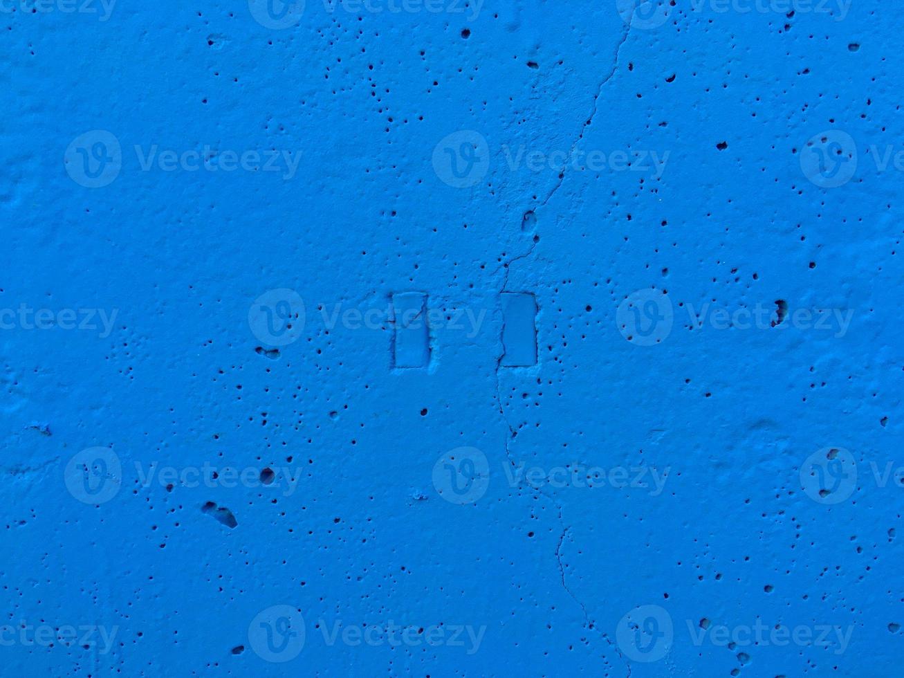 Depressions in the form of a stop button. Azure wall. Put your text here photo