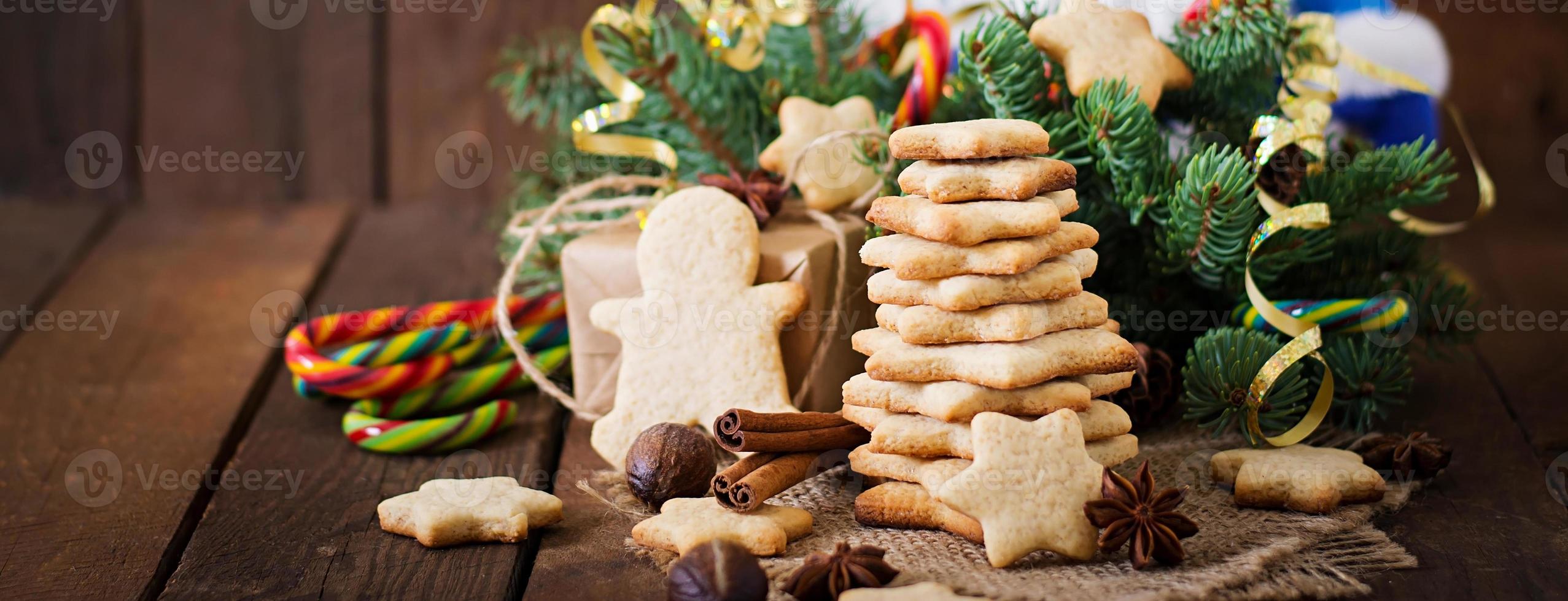 Christmas cookies and tinsel on a wooden background photo