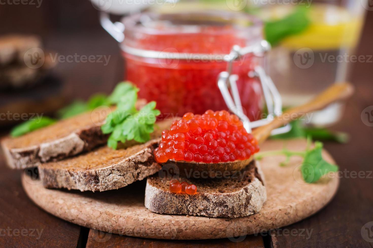 Bank with red caviar and bread photo