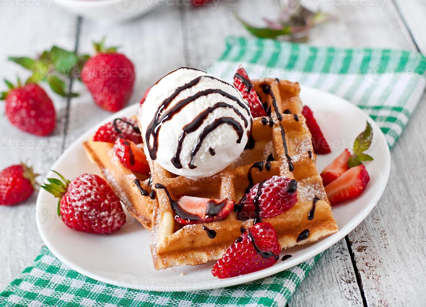 Belgium waffles with strawberries and ice cream  on white plate photo