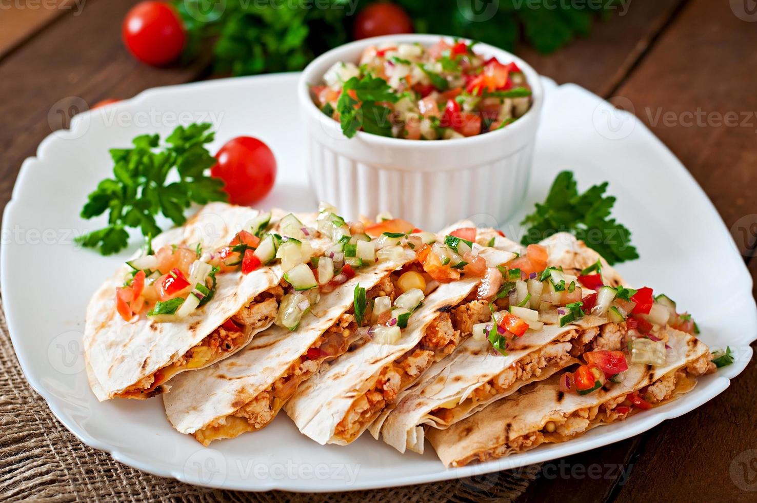 Mexican Quesadilla wrap with chicken, corn and sweet pepper and salsa photo