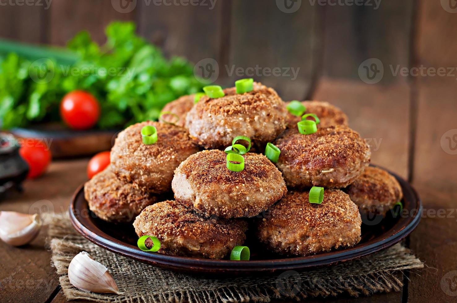 Juicy delicious meat cutlets on a wooden table in a rustic style. photo