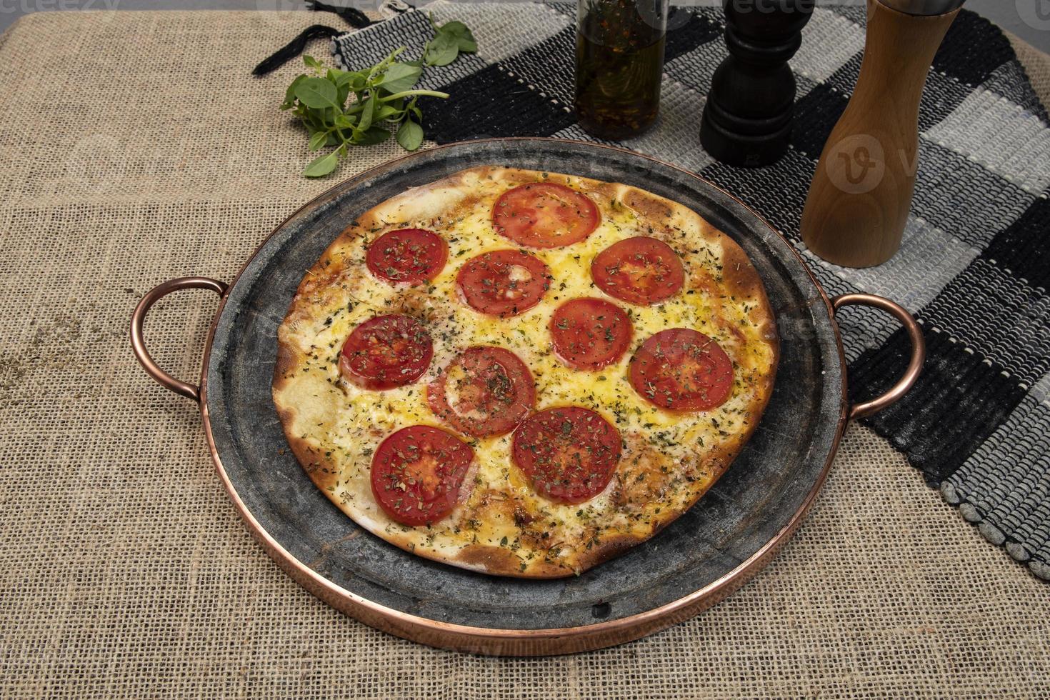 Neapolitan Brazilian pizza with mozzarella cheese and tomato slices with oregano photo