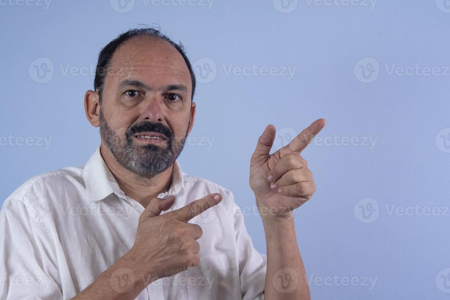 Portrait of 60 years old bearded man on blue background photo