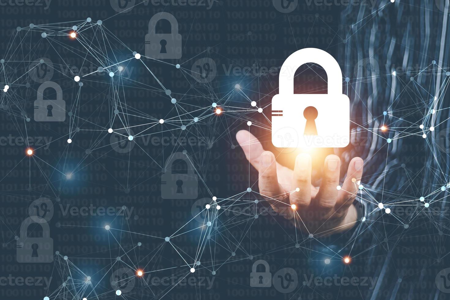 cyber security concept Man's hand using a computer showing a padlock icon to show that the smartphone is protected from hackers from hacking, logging in. online trading or use of social media photo