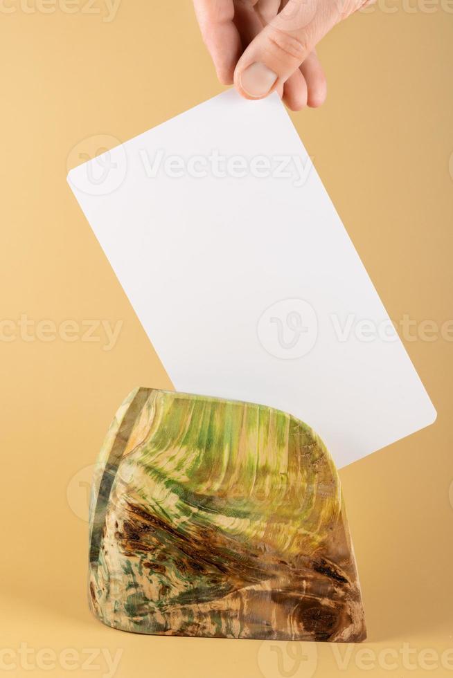 A table stand made of stabilized maple wood with a white label on a yellow background. To showcase products or photo frames. layout