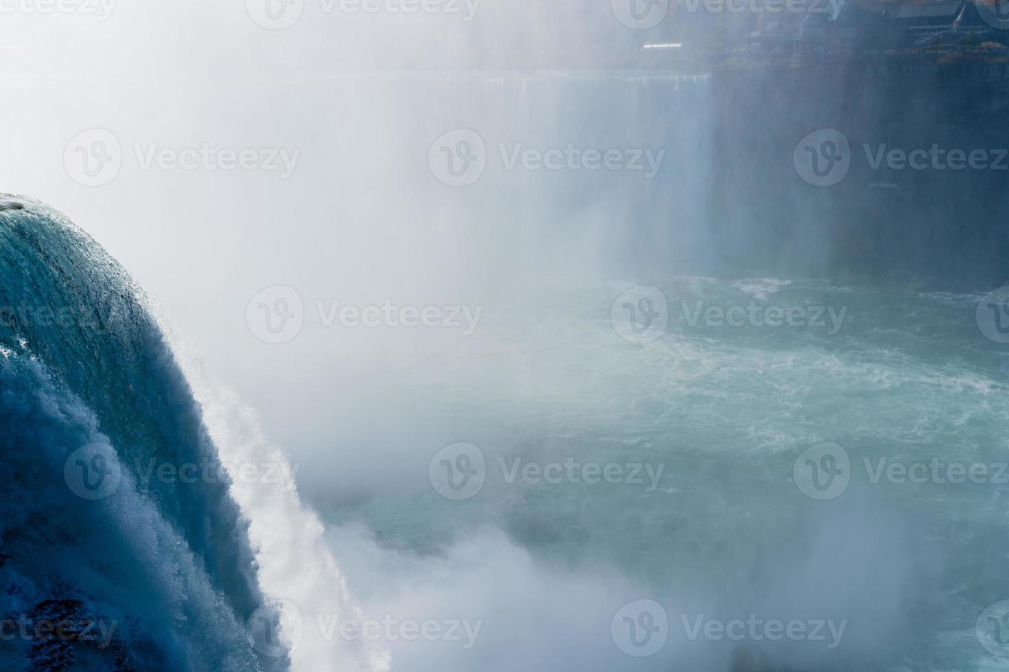 Niagara Falls from the American and Canadian sides. Rainbow over the waterfall. The most popular tourist place. Stormy river that flows into the lake. photo