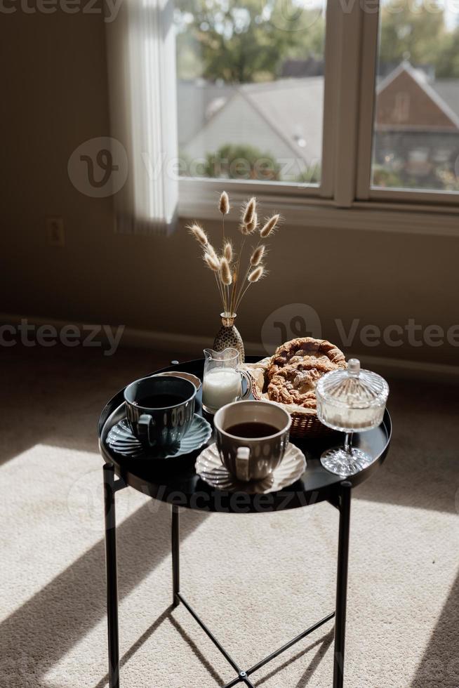 Aesthetic breakfast. Milk coffee, milk tea, sugar, almond, almond cakes, biscuits, marzipans and puffs. British breakfast in a cozy home. Autumn mood. photo