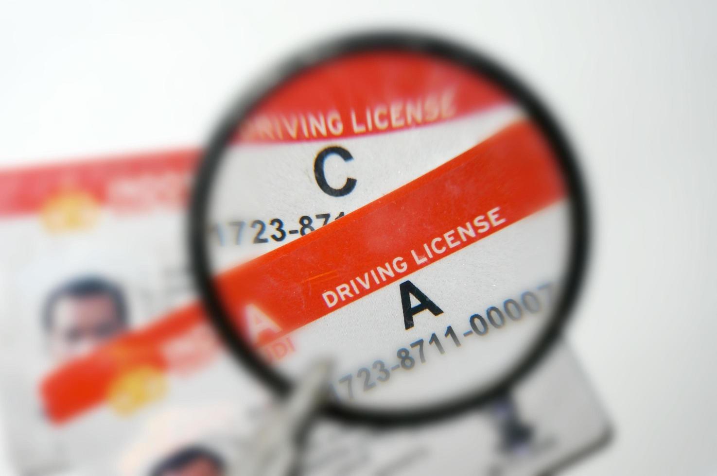 indonesia Driving License under magnifying glass with selective focus photo