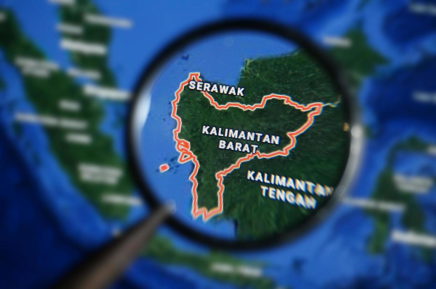 West Kalimantan map under magnifying glass with selective focus photo