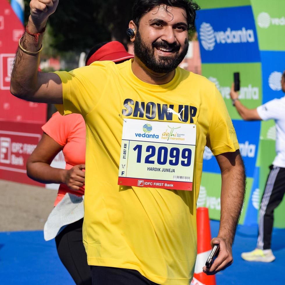 New Delhi, India - October 16 2022 - Vedanta Delhi Half Marathon race after covid in which marathon participants about to cross the finish line, Delhi Half Marathon 2022 photo