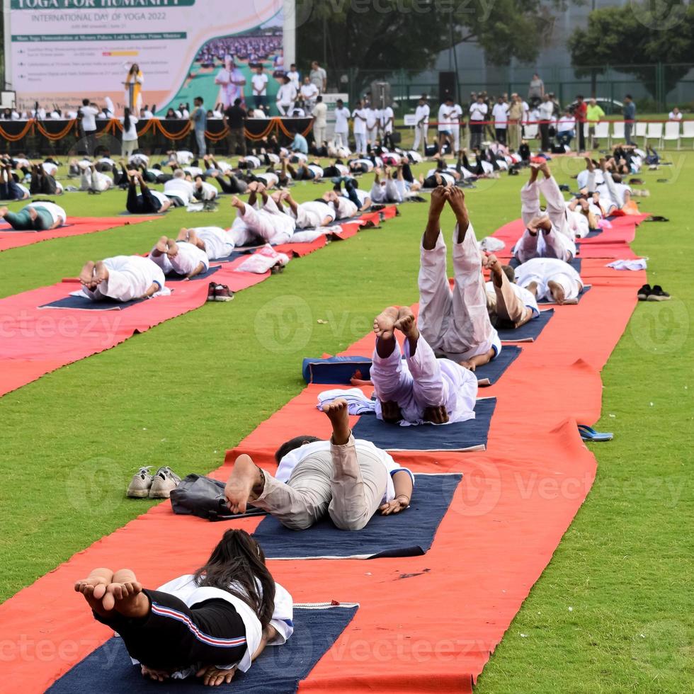 Group Yoga exercise session for people of different age groups at cricket stadium in Delhi on International Yoga Day, Big group of adults attending yoga session photo