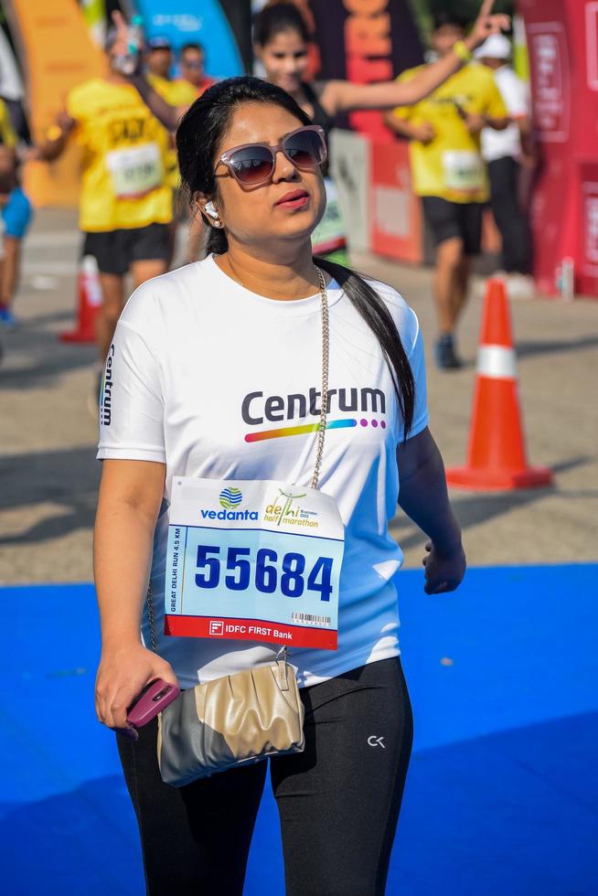 New Delhi, India - October 16 2022 - Vedanta Delhi Half Marathon race after covid in which marathon participants about to cross the finish line, Delhi Half Marathon 2022 photo