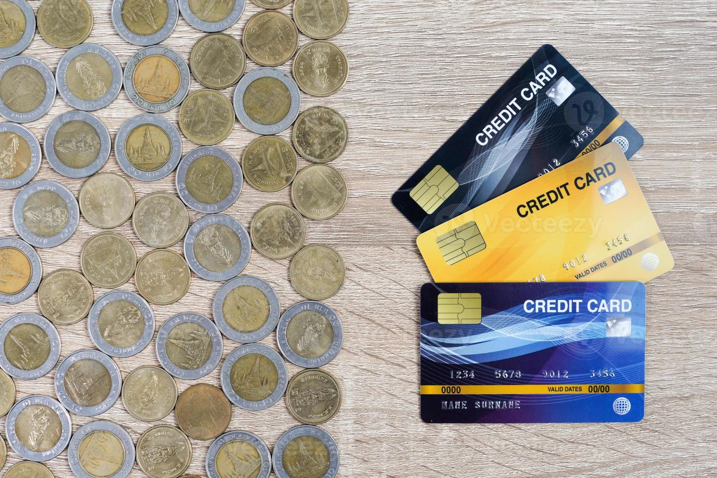 Top view house model and coins with credit card on wood table photo