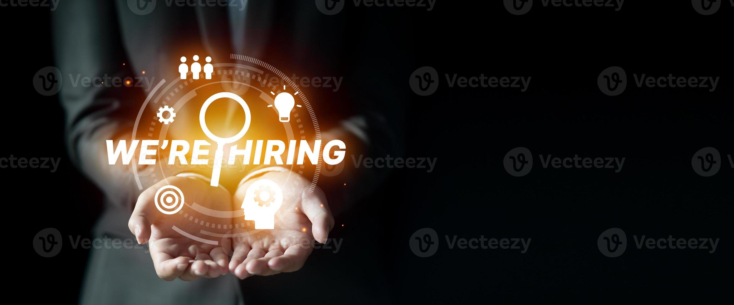 Businessman showing job vacancy concept with icons on virtual screen, We are hiring background photo