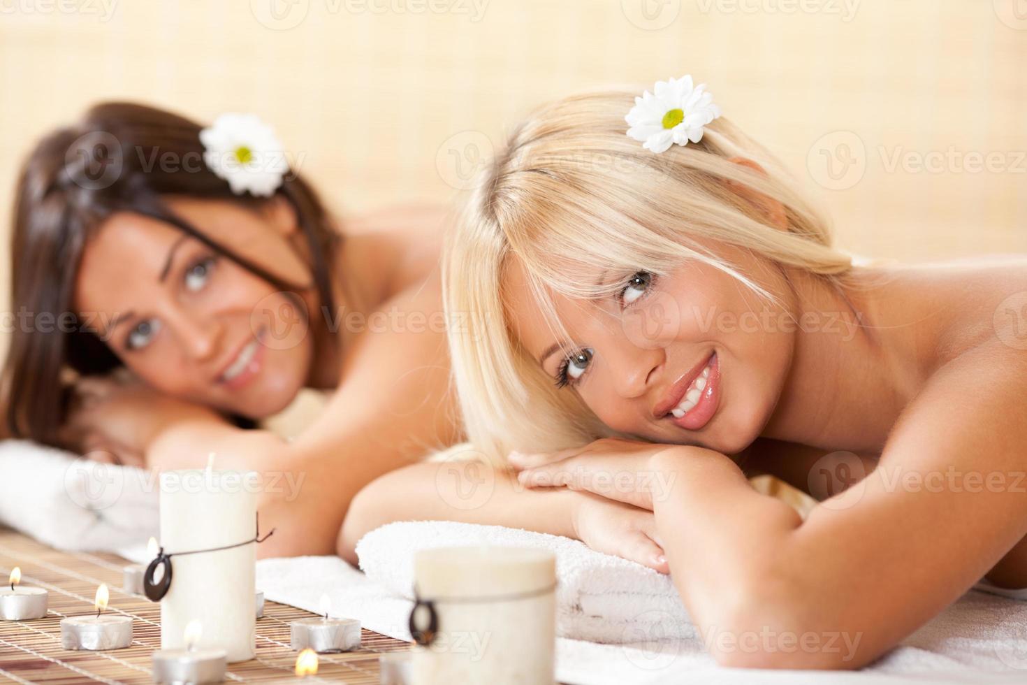 Two young women relaxing at the spa center photo