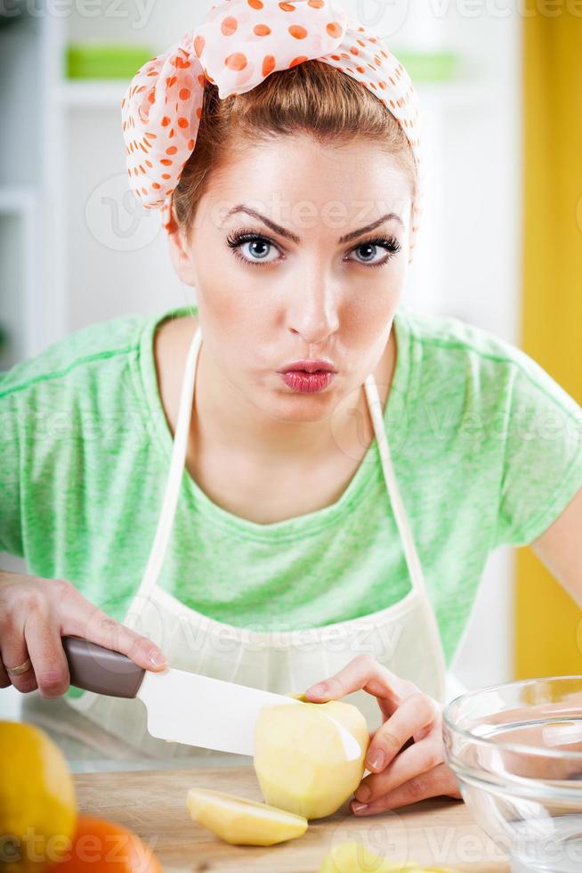 Young woman slicing apple photo