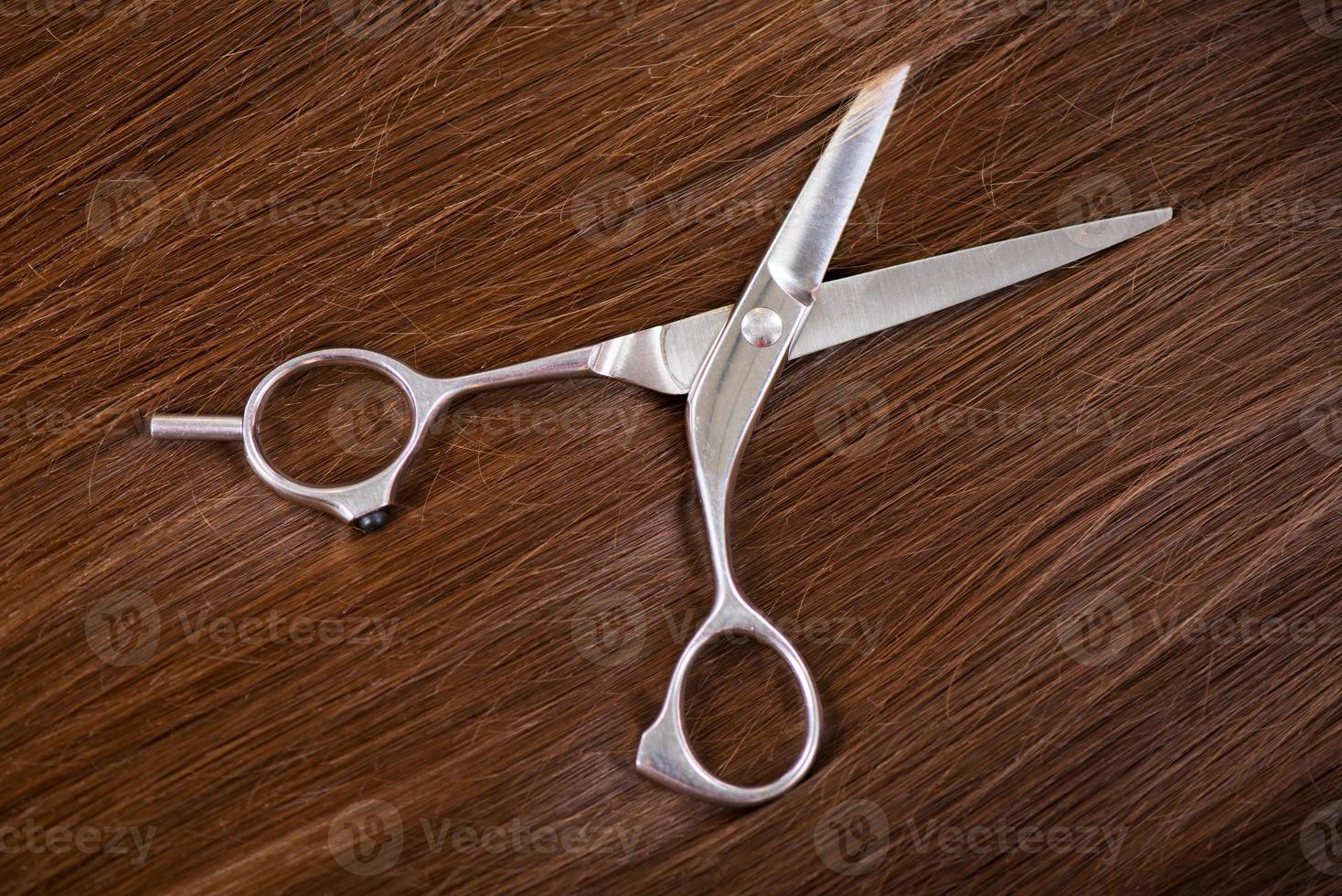 Closeup of scissors on hair photo