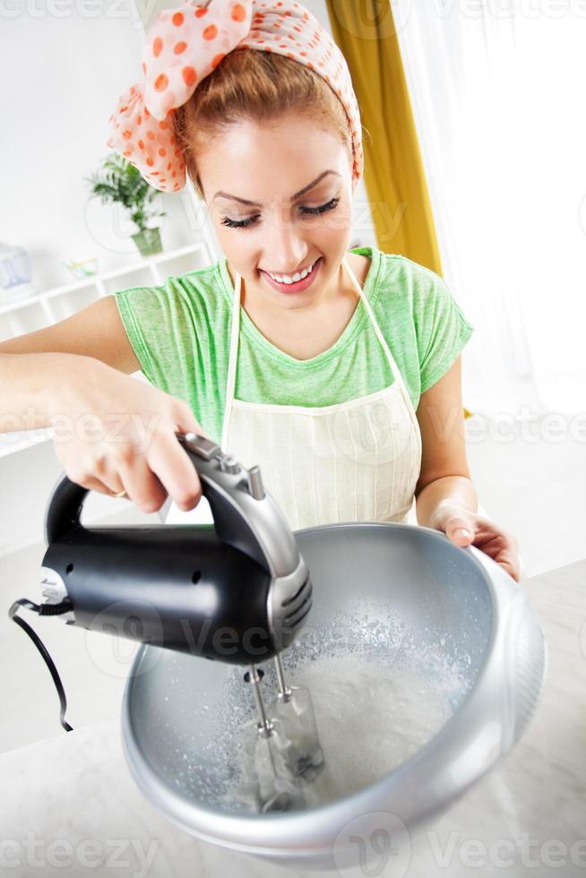 Young woman mixing of cream photo