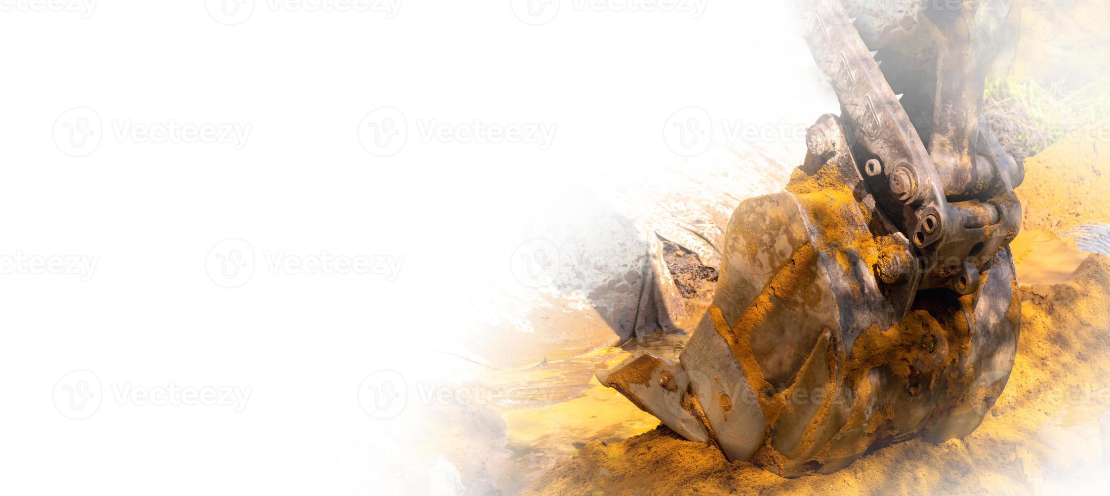 The road excavator bucket distributes the sand, creating a fentry through the ditch. Close-up image on the white background. Copy space. photo